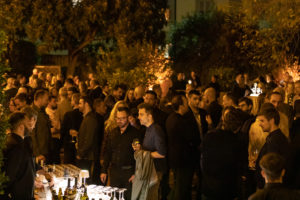 People are chatting with each other during the evening event.